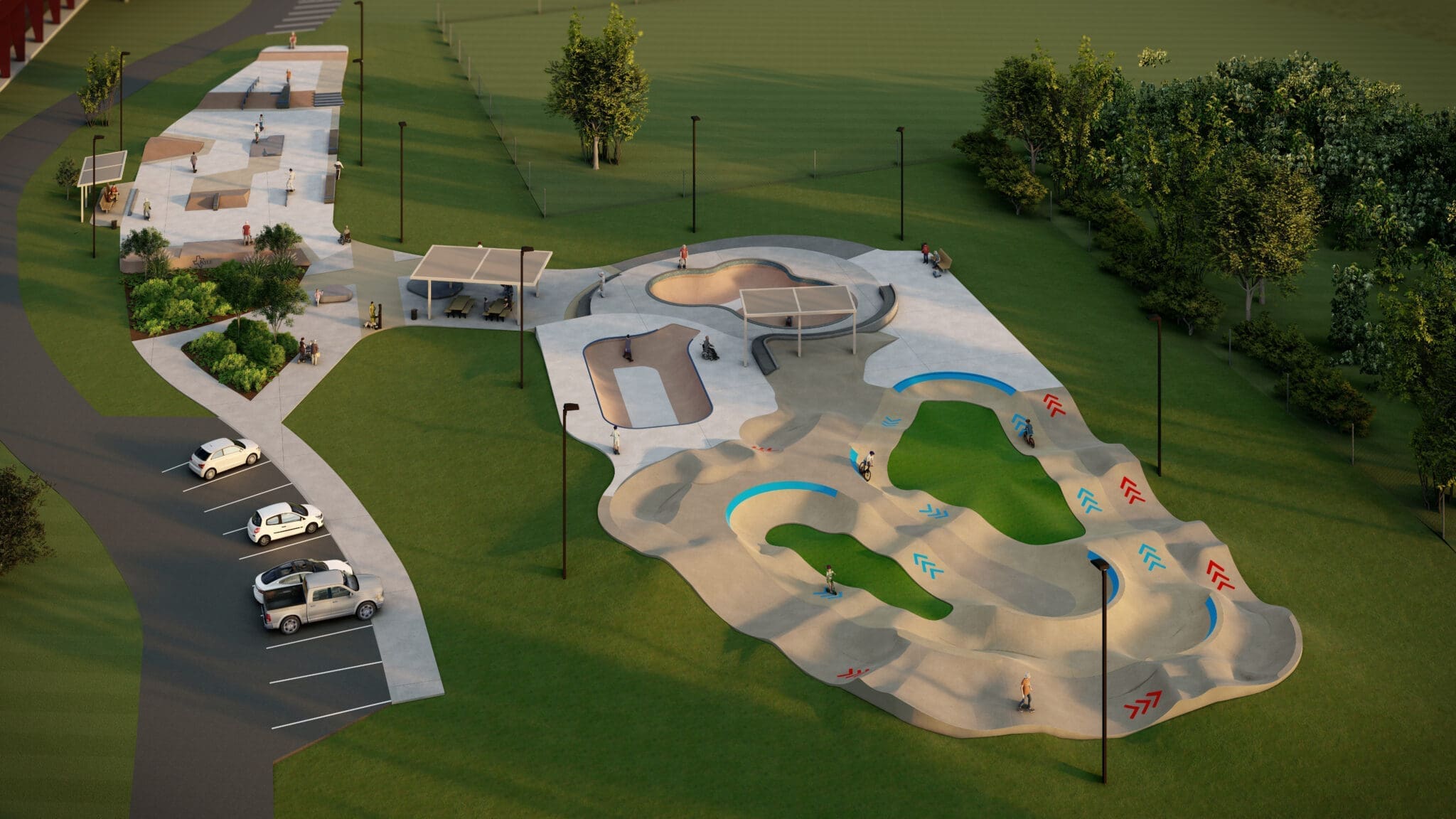 Aerial view of a modern skatepark with multiple concrete ramps, bowls, and pathways. A few people use the park, and several cars are parked nearby. The park is surrounded by grass, trees, and walking paths.