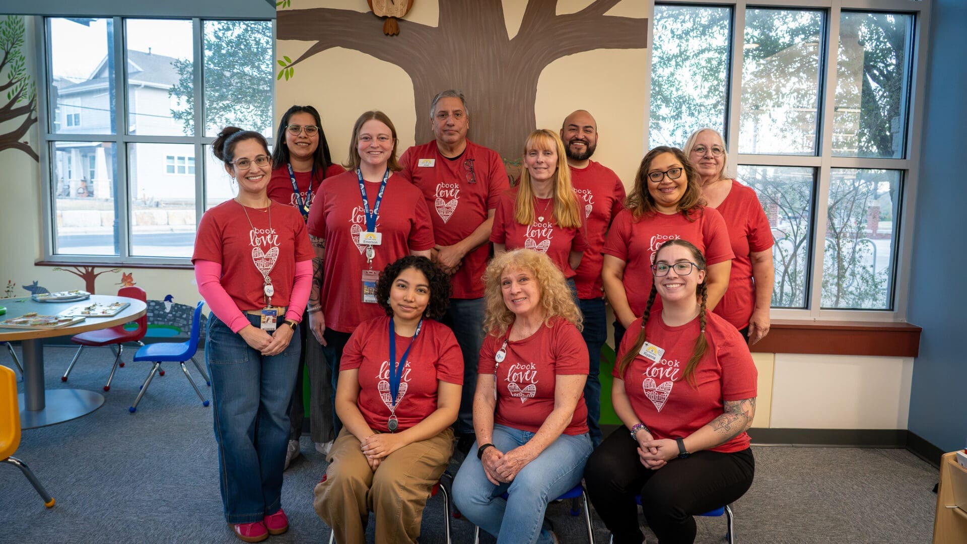 A group of people wearing matching red shirts.