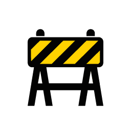 A construction barricade with black and yellow diagonal stripes on a rectangular sign, supported by two black legs, symbolizing caution or restricted access.