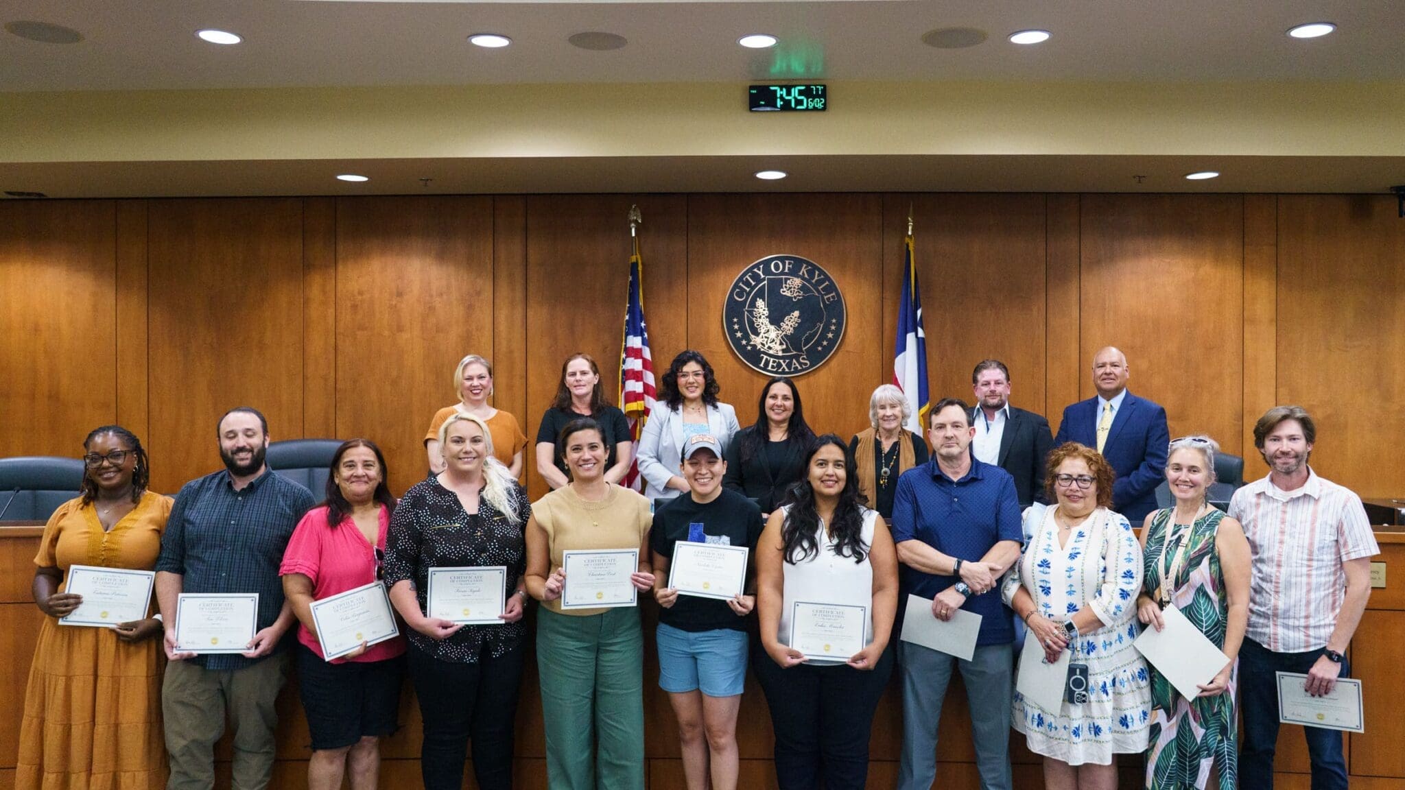 Members of the 2026 graduating class of Team Kyle Academy pose with members of Kyle City Council at the June 2, 2026 meeting as part of their mini graduation ceremony.